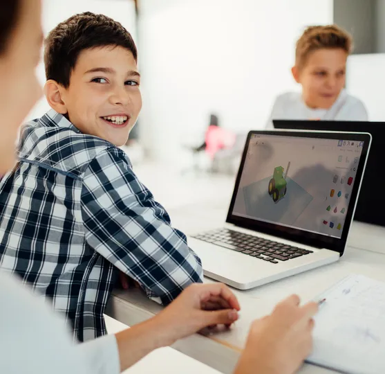 Boy designing a 3D model on a laptop